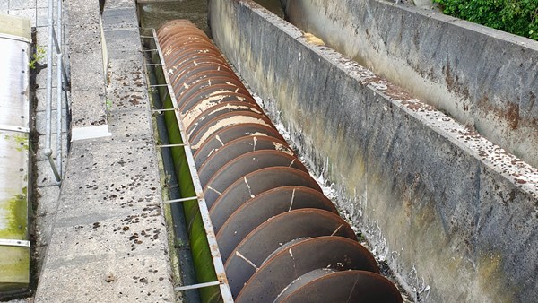 Screw pump in a chute at a sewage plant.